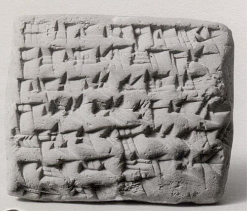 Ancient clay tablet covered in cuneiform script
