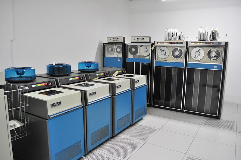 Row of early mainframe computers with tape drives